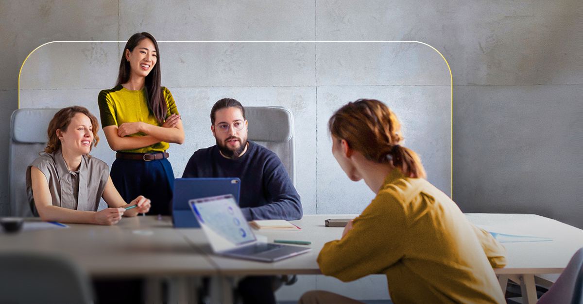 Team meeting around a table with laptops